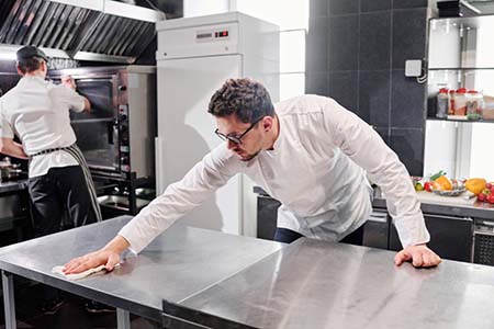 Chef cleaning a kitchen